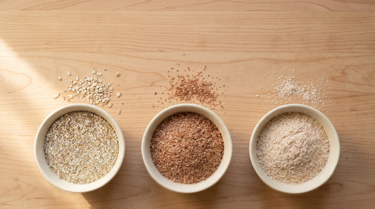 Rye bran, wheat bran and oat bran side by side in three bowls, showing their different colour and texture