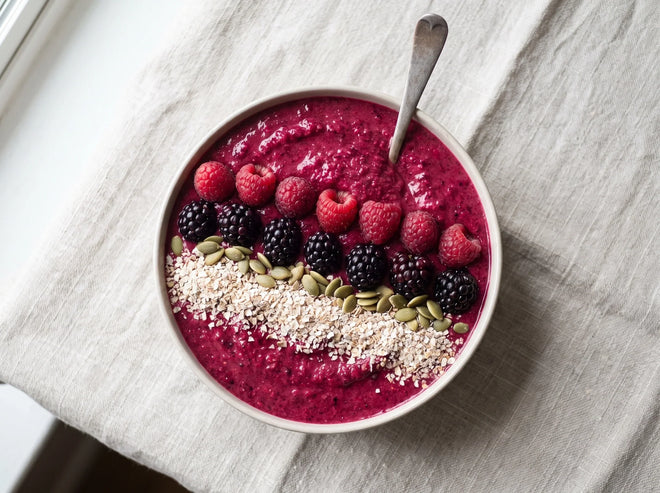 A thick berry smoothie bowl made with Ryedical rye bran and topped with fresh berries and seeds